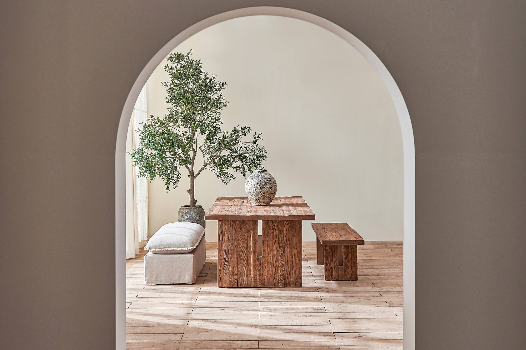 A Kai Dining Table in Heritage Oak is placed in between a Neva Dining Bench and Kai Dining Bench
