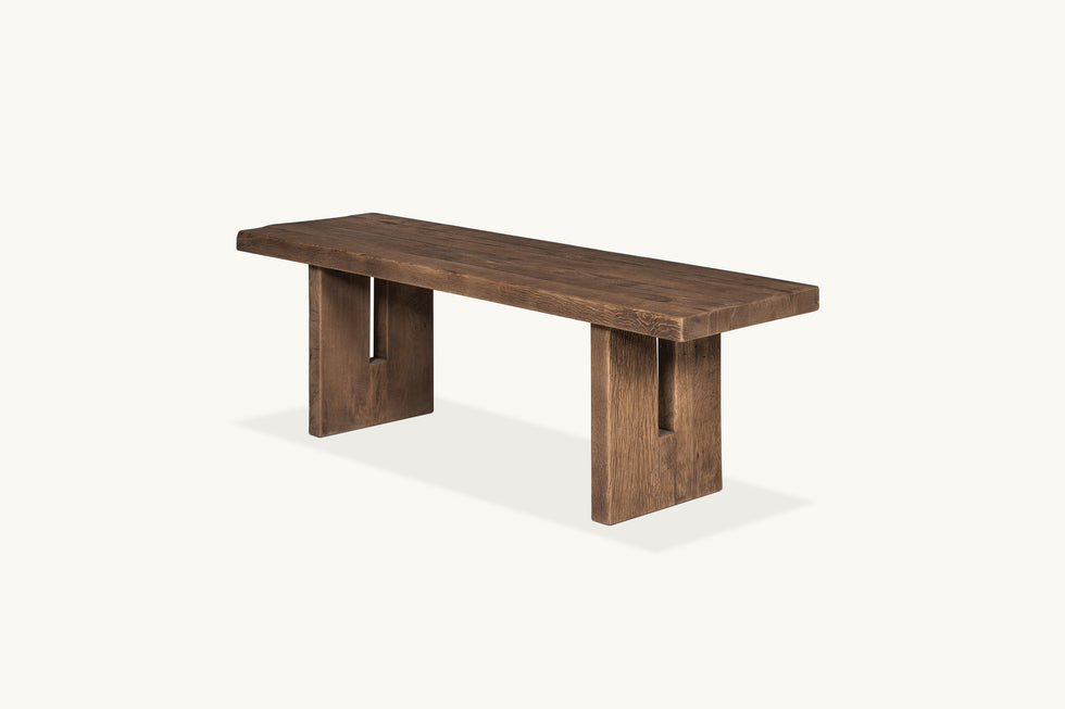 Angled view of Kai Dining Bench in 100% Reclaimed Austrian Heritage Oak, a medium, bosc pear shade with earthy undertones