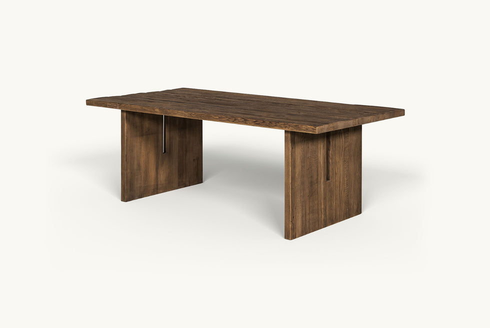 Angled view of Kai Dining Table in 100% Reclaimed Austrian Heritage Oak, a medium, bosc pear shade with earthy undertones
