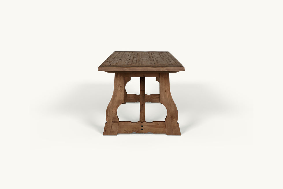 Side view of Leona Dining Table in 100% Reclaimed Chinese Heritage Pine, a medium, bosc pear shade with earthy undertones