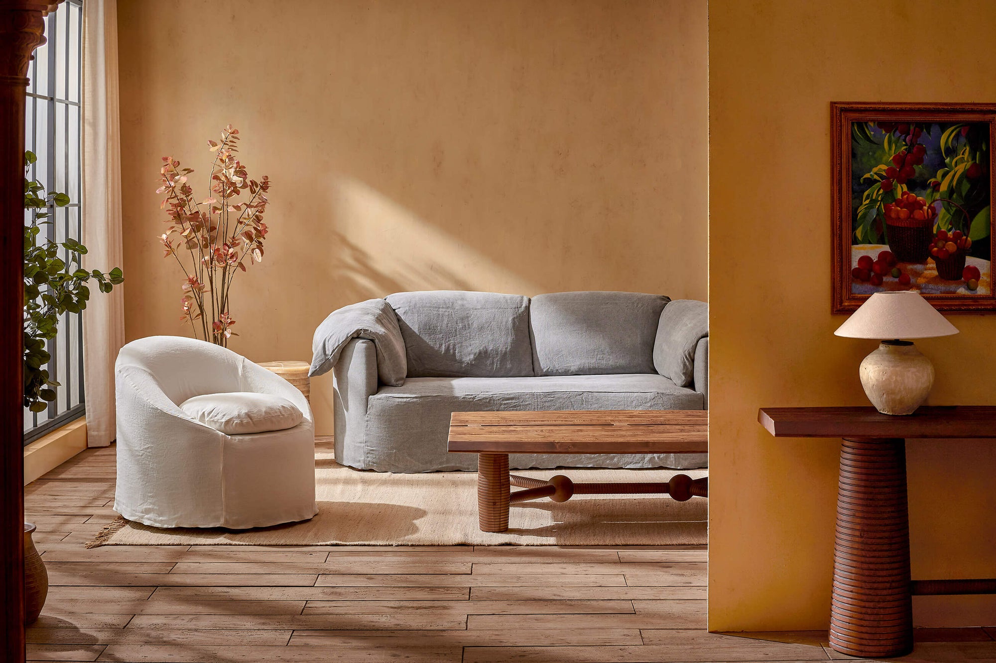 Loula Sofa in Ink Cap, a medium cool grey Light Weight Linen,with an Ozzi Chair and Zenia Coffee Table