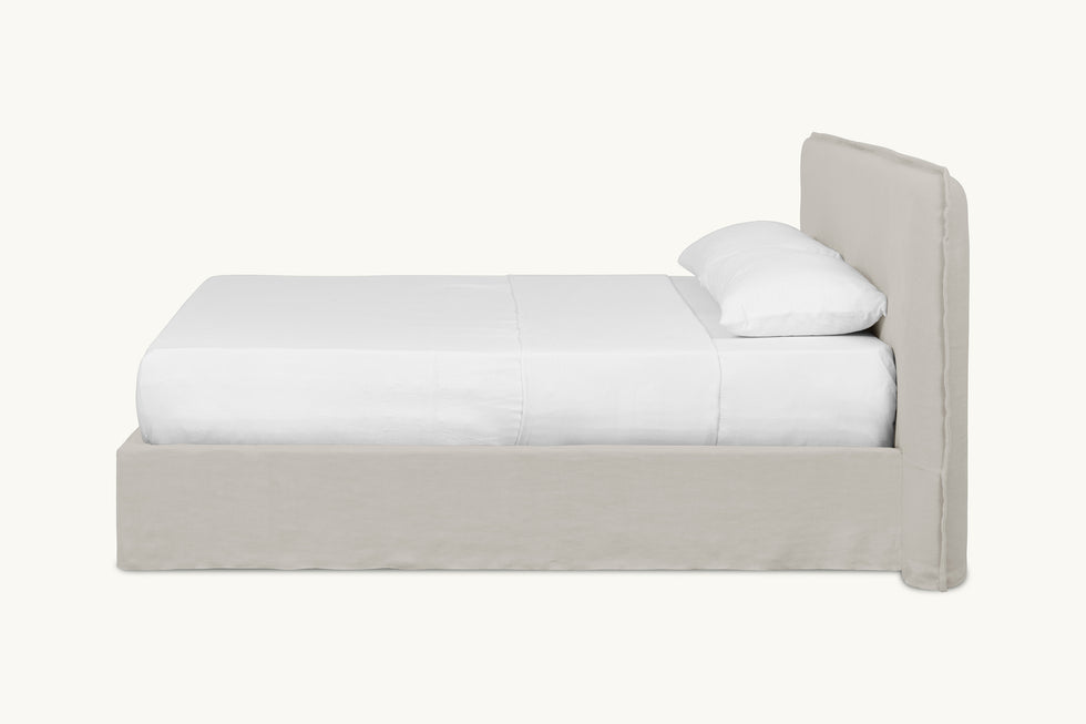 Side view of Neva King Bed in Jasmine Rice, a light warm greige Medium Weight Linen