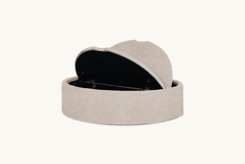 Open view of Neva Round Storage Ottoman in Oat Flour, a medium taupe Light Weight Linen