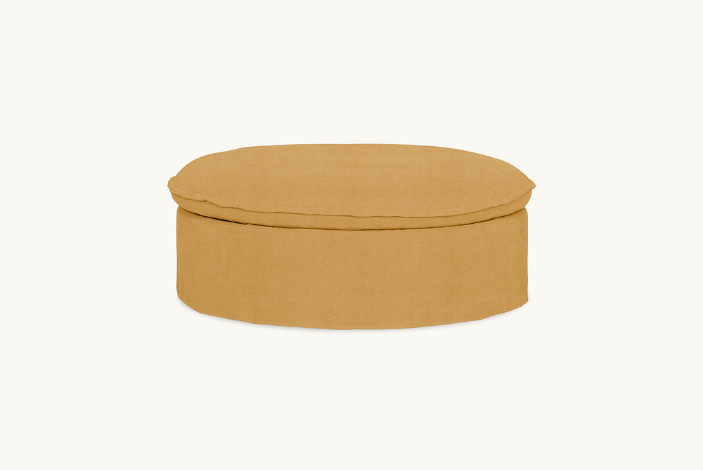Neva Round Storage Ottoman in Honey Bee, a saffron yellow Thread-Dyed Cotton Linen