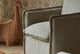 Slide #6 Close up of Neva Swivel Glider Chair in Jasmine Rice, a light warm greige Medium Weight Linen placed in a nursery decorated room