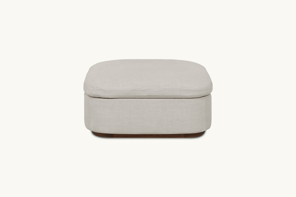 Front view of Olea Storage Ottoman in Jasmine Rice, a light warm greige Medium Weight Linen