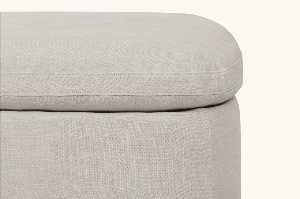 Close up of Olea Storage Ottoman in Jasmine Rice, a light warm greige Medium Weight Linen
