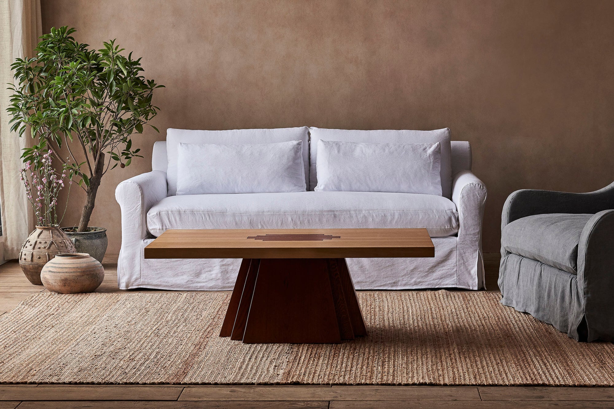 A Rigo Coffee Table placed in front of the Elias Sofa on top of a rug