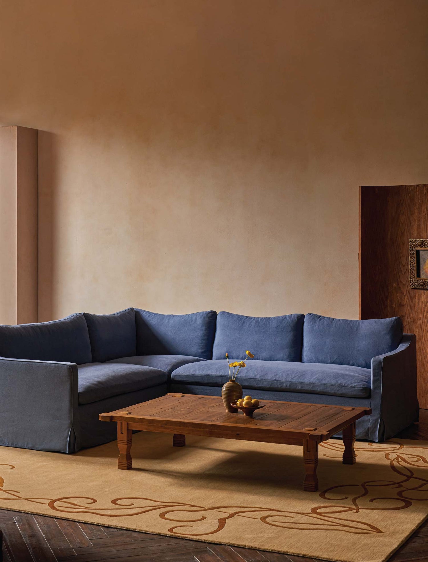 sixpenny-amelia-l-shape-sectional-garden-berry in a living room with sixpenny ora coffee table and sixpenny wander crane rug.