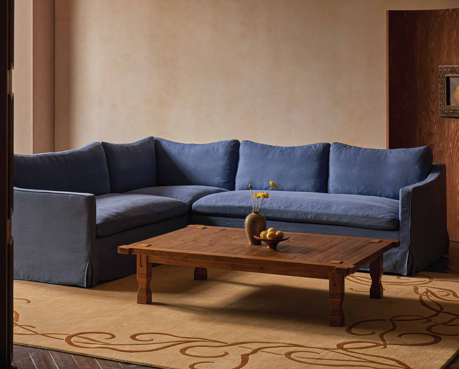 sixpenny-amelia-l-shape-sectional-garden-berry in a living room with sixpenny ora coffee table and sixpenny wander crane rug.