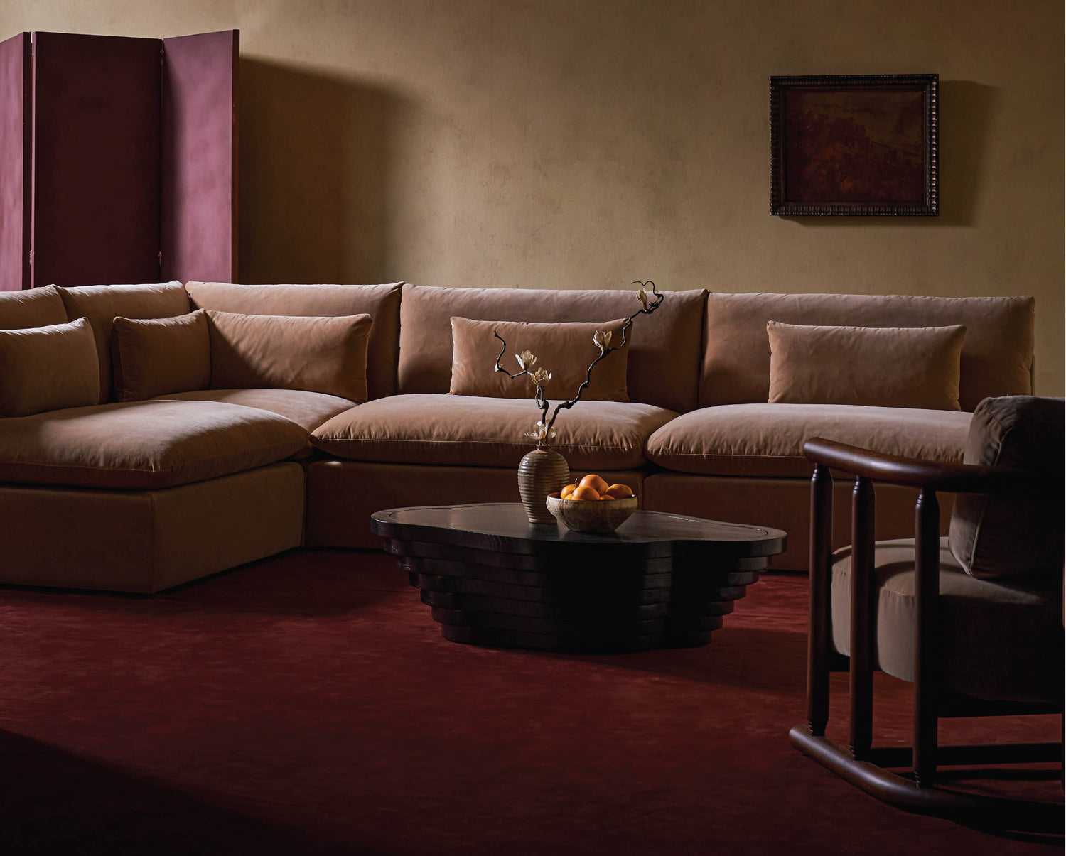 Living room with sixpenny aria grande corner sectional sofa, tera coffee table, and gio chair