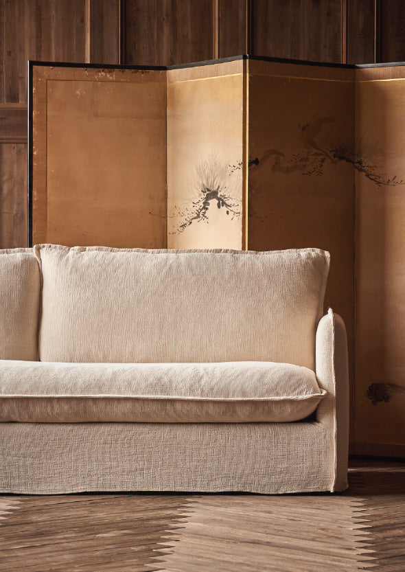 sixpenny neva sofa in a room with wooden walls