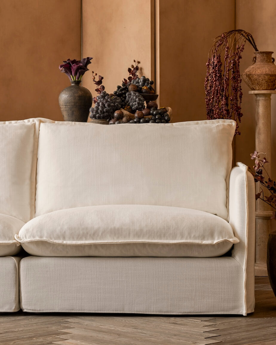 Neva Sectional in First Light, a warm white linen-like recycled polyester.