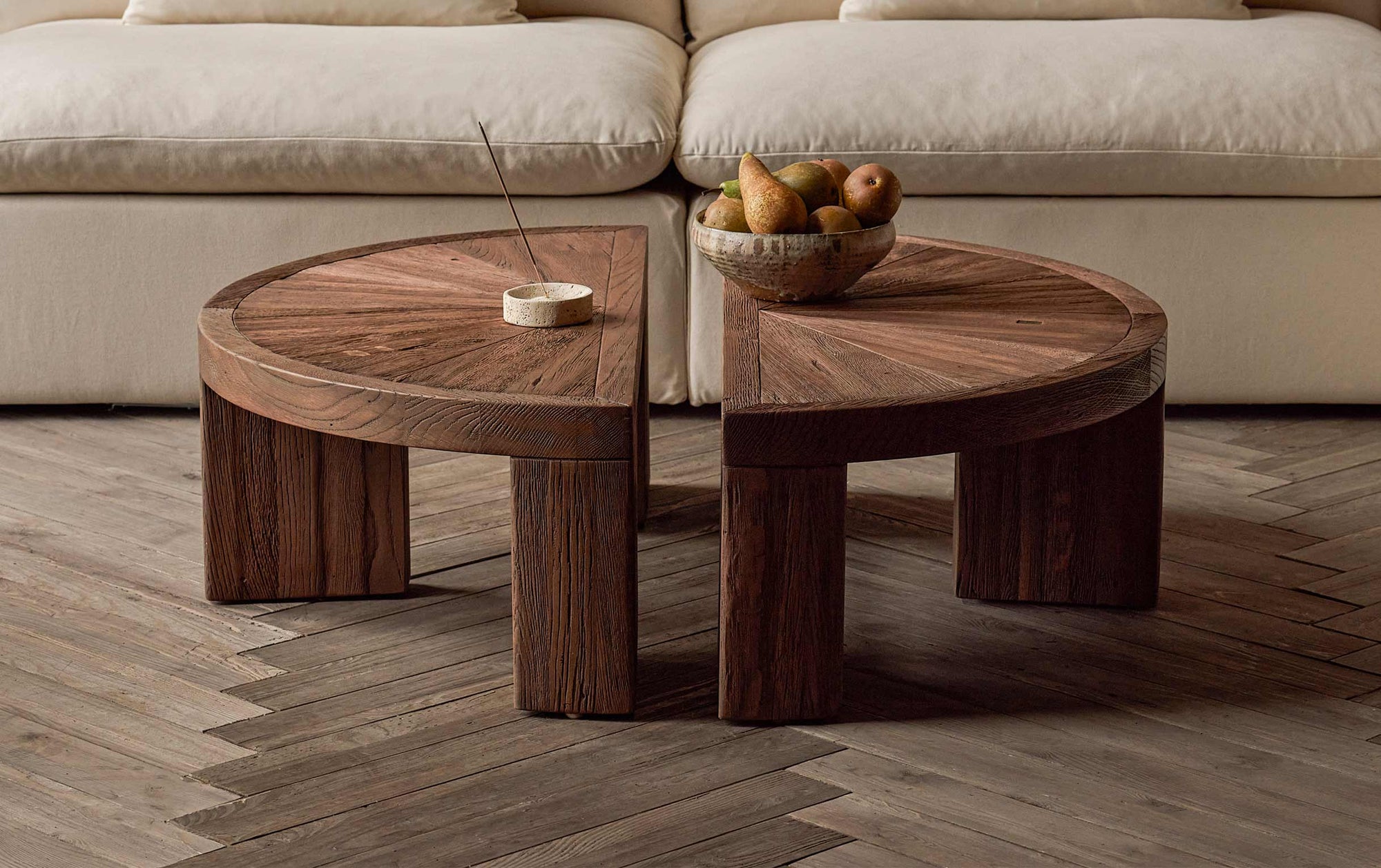 Tango Coffee Table (2pc) in 100% Reclaimed Austrian Heritage Oak, a medium, bosc pear shade with earthy undertones, placed on a wood floor in front of an Aria Sofa