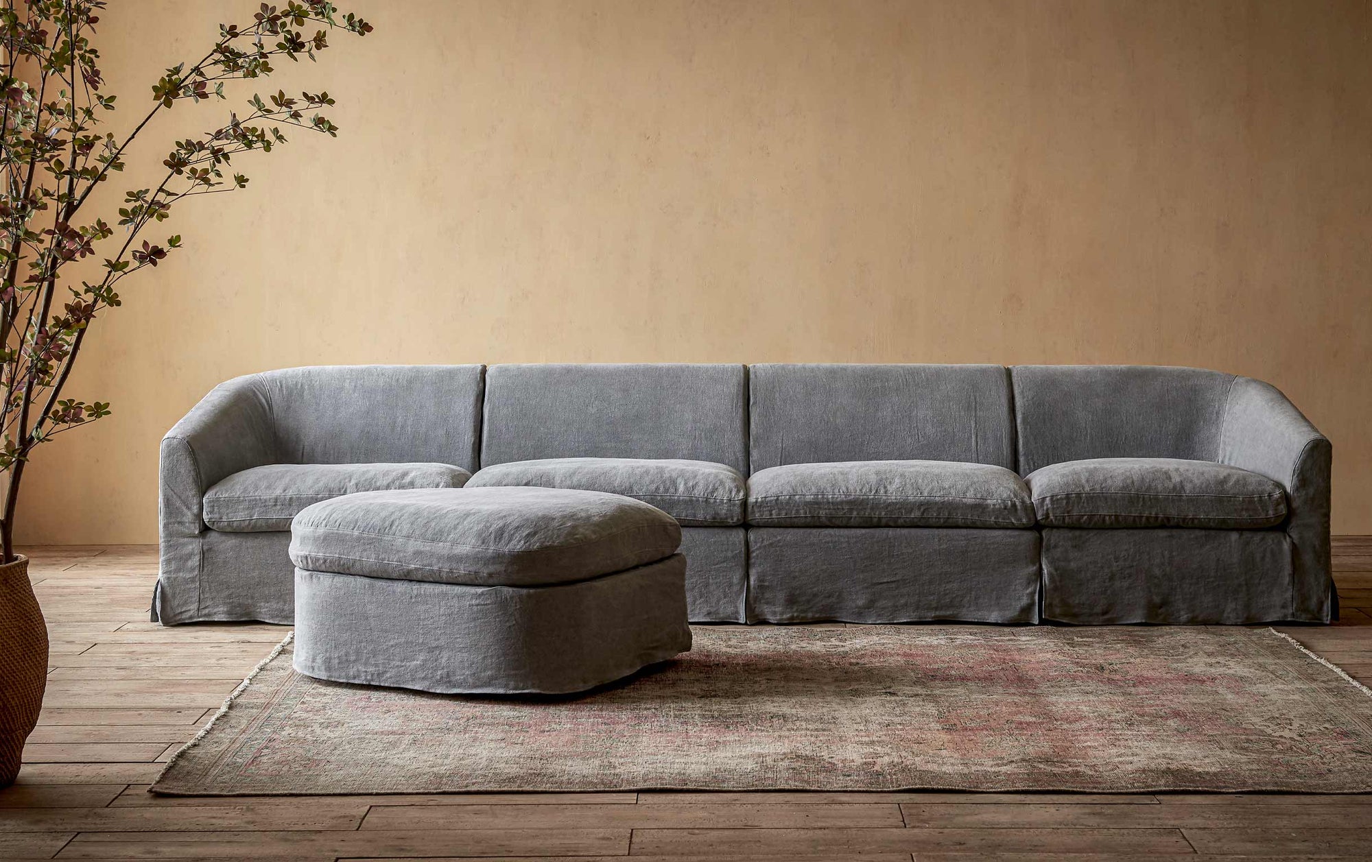 Ziki 5-Piece Chaise Sectional Sofa in Ink Cap, a medium cool grey Light Weight Linen, placed in a room with a floor plant