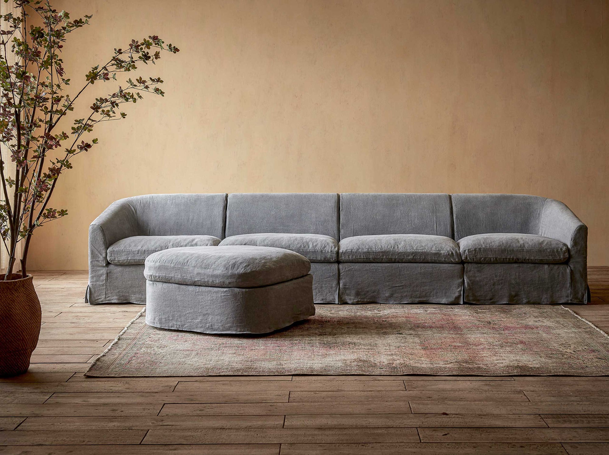 Ziki 5-Piece Chaise Sectional Sofa in Ink Cap, a medium cool grey Light Weight Linen, placed in a room with a floor plant