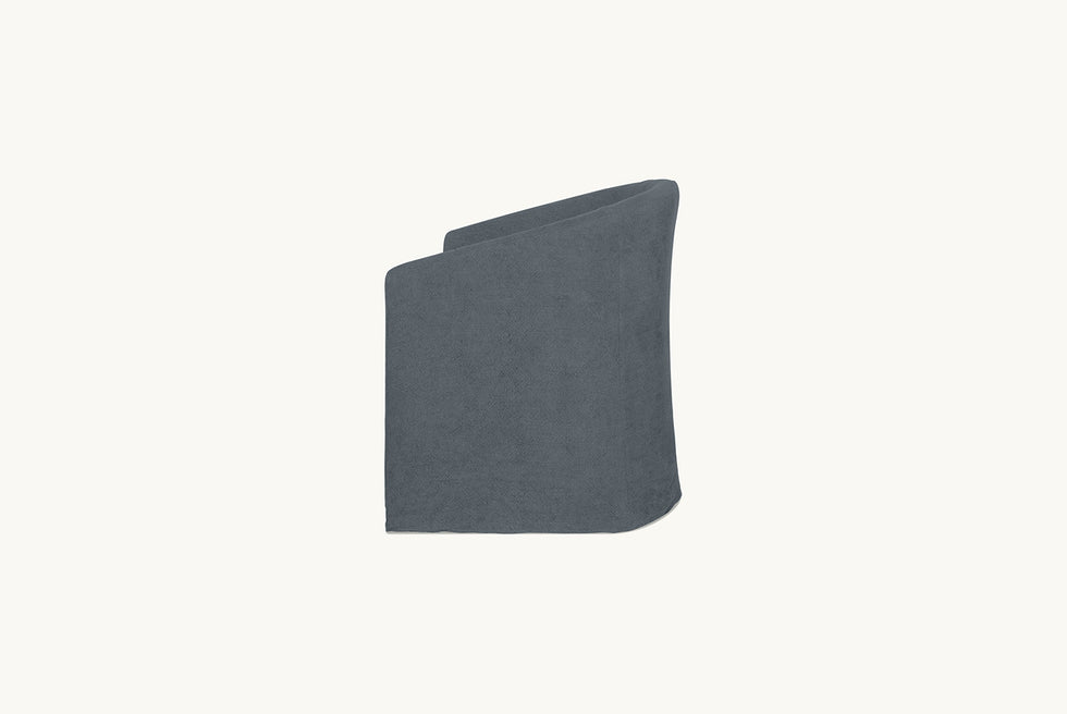Side shot of a Ziki Dining Chair in Ink Cap, a medium cool grey Light Weight Linen
