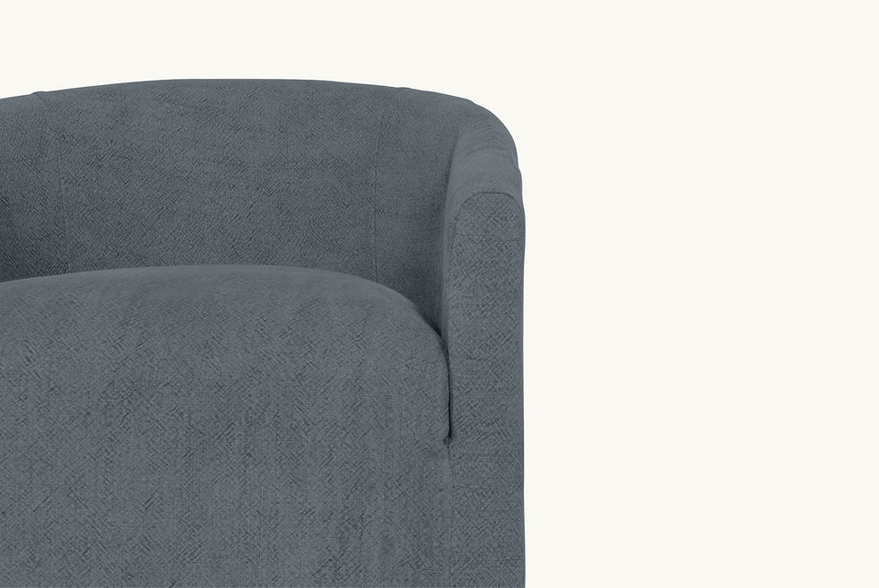 Close up shot of a Ziki Dining Chair in Ink Cap, a medium cool grey Light Weight Linen