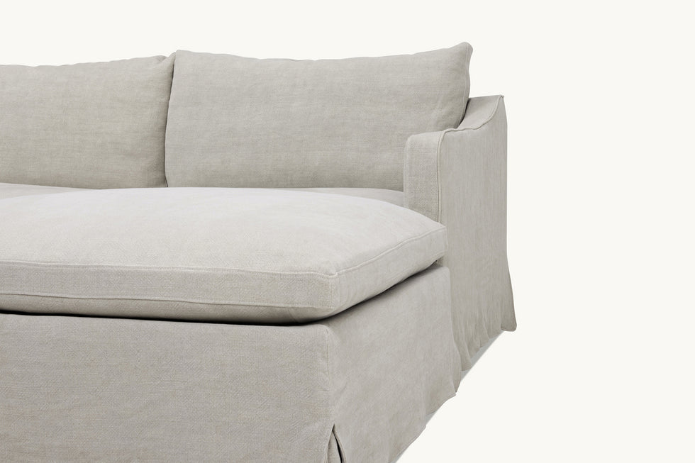 Close up view of Amelia 4-piece Chaise Sectional Sofa in Jasmine Rice, a light warm greige Medium Weight Linen
