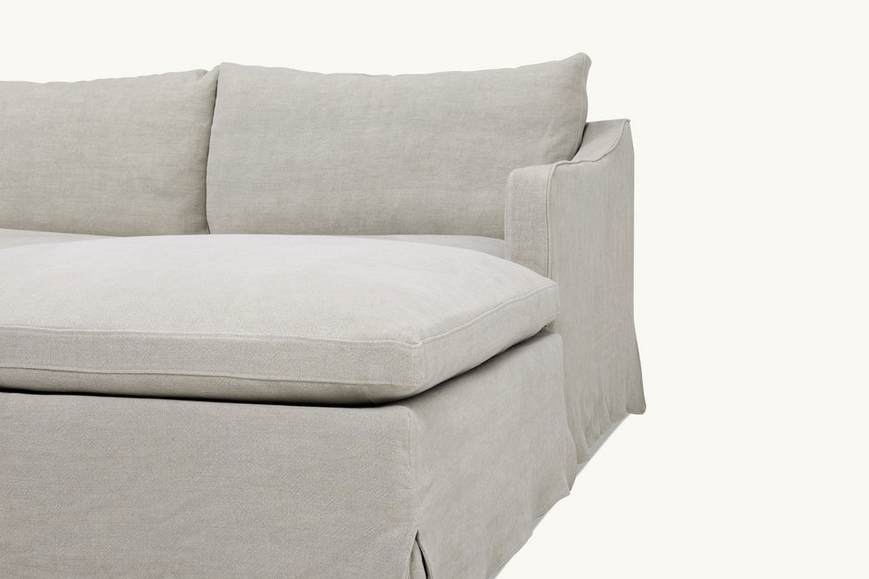 Close up view of Amelia 4-piece Chaise Sectional Sofa in Jasmine Rice, a light warm greige Medium Weight Linen