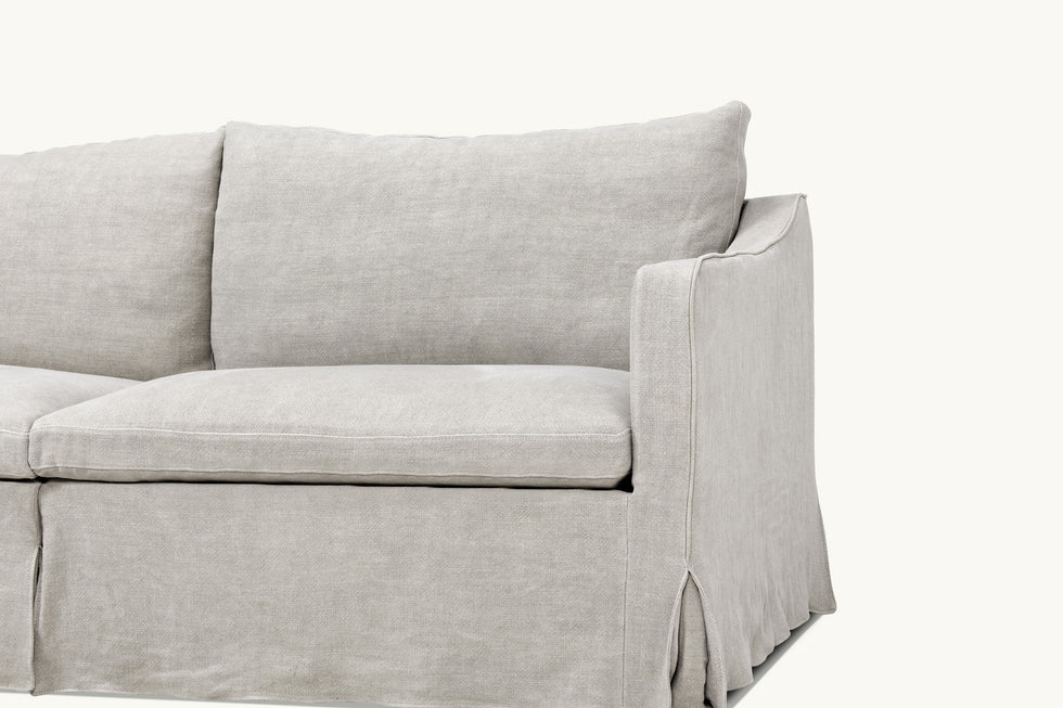 Close up view of Amelia Sectional Sofa in Jasmine Rice, a light warm greige Medium Weight Linen