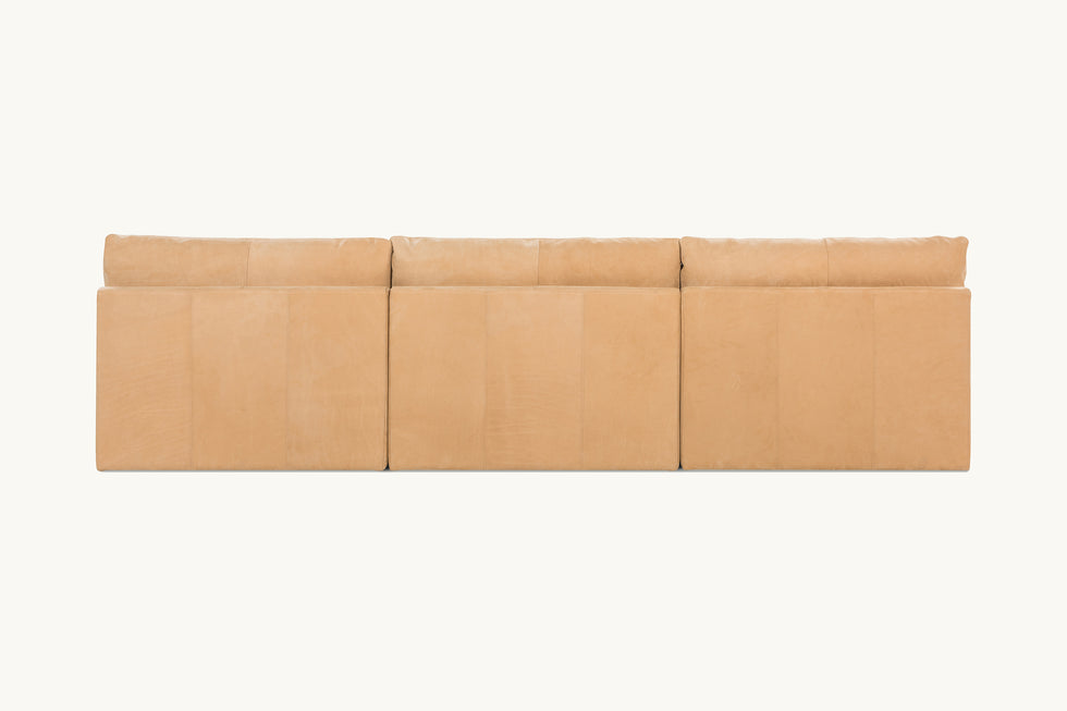 Back view of Aria Leather 4-piece Chaise Sectional Sofa in Mojave Glow, a tan Meridian Leather