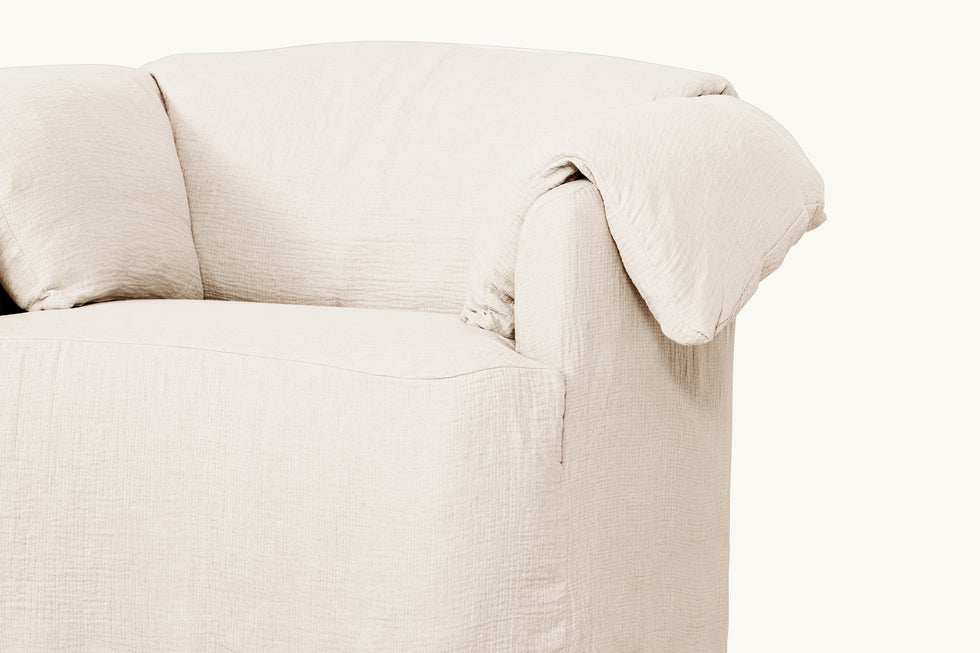 Close-up view of Loula Swivel Chair in Corn Silk, a light beige Washed Cotton Linen