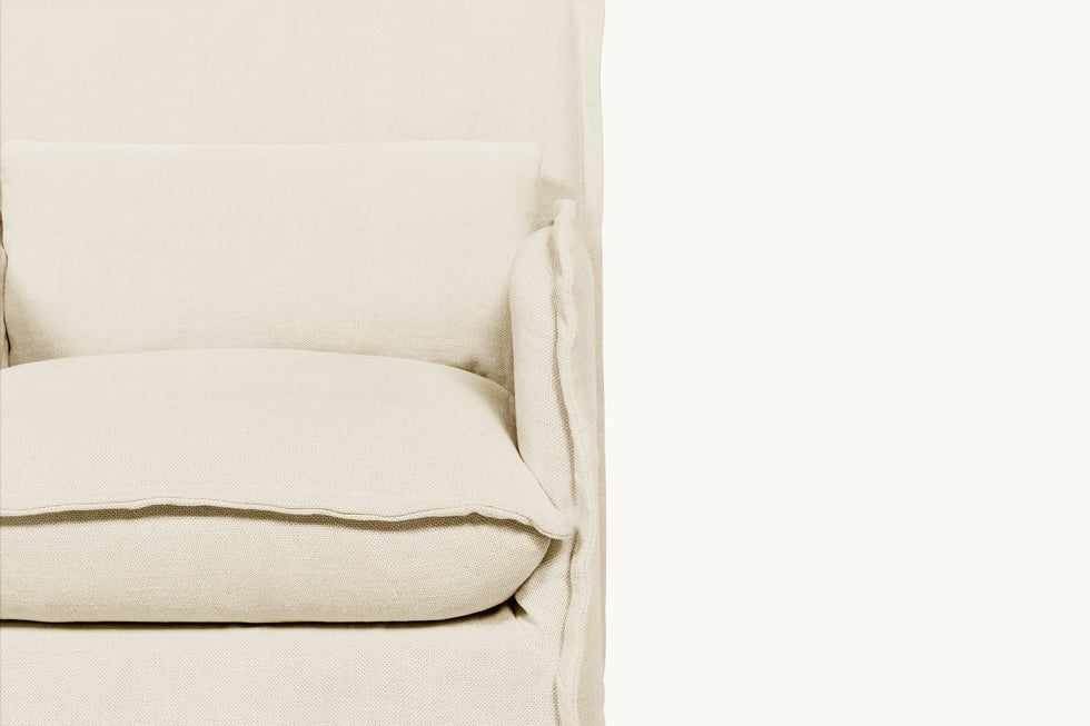 Close up front view of a Melo Dining Chair in Warm Oatmeal, a light warm beige Medium Weight Linen