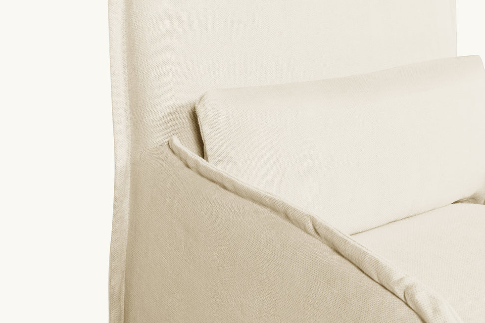 Close up side view of a Melo Dining Chair in Warm Oatmeal, a light warm beige Medium Weight Linen