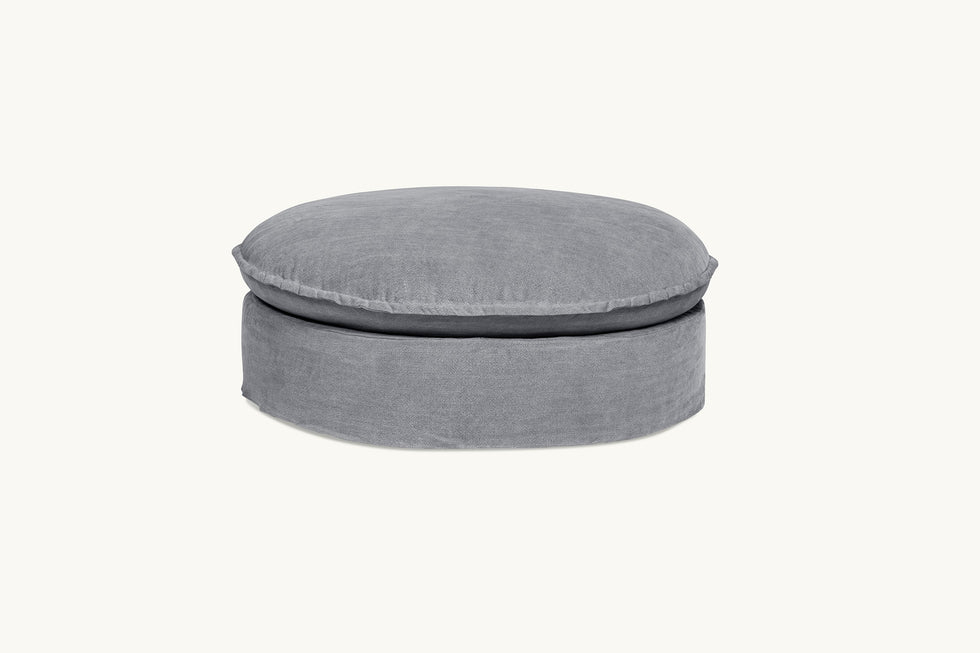 Front view of Neva Round Ottoman in Ink Cap, a medium cool grey Light Weight Linen