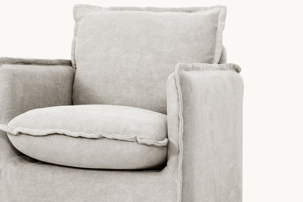 Close-up view of Neva Swivel Glider Chair in Jasmine Rice, a light warm greige Medium Weight Linen