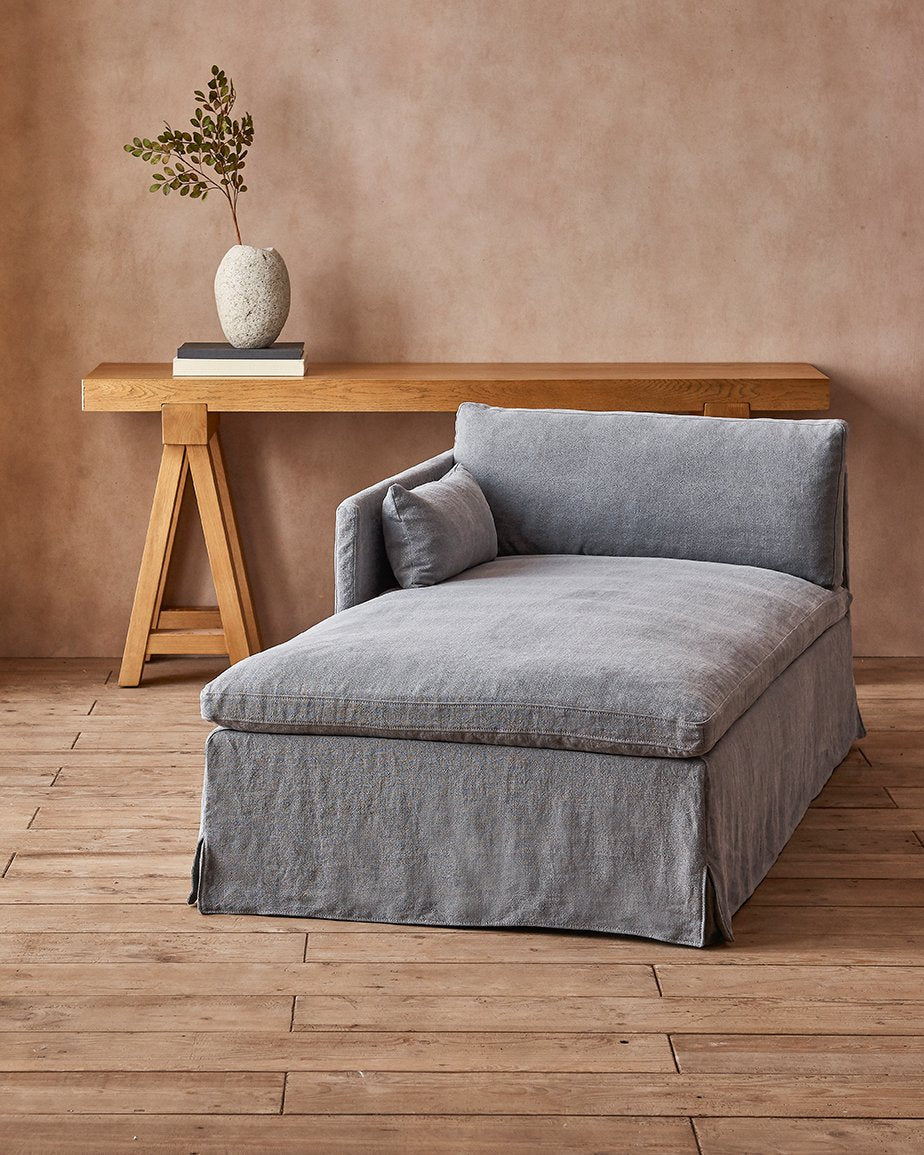 Gabriel Daybed in Ink Cap, a medium cool grey Light Weight Linen, placed in a room in front of a plant in a vase on a table
