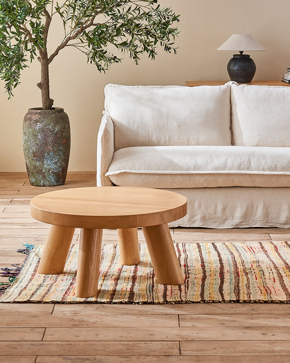 Chloe Coffee Table in Pale Oak placed in a room in front of the Neva Sofa